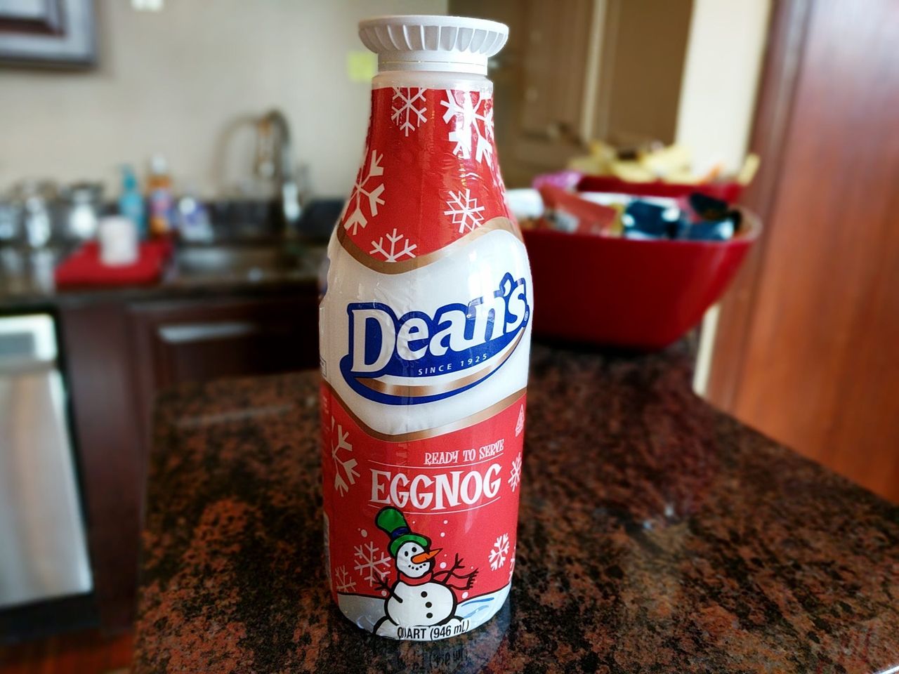 A bottle of Dean’s Eggnog with a snowman on the label, on a granite counter
