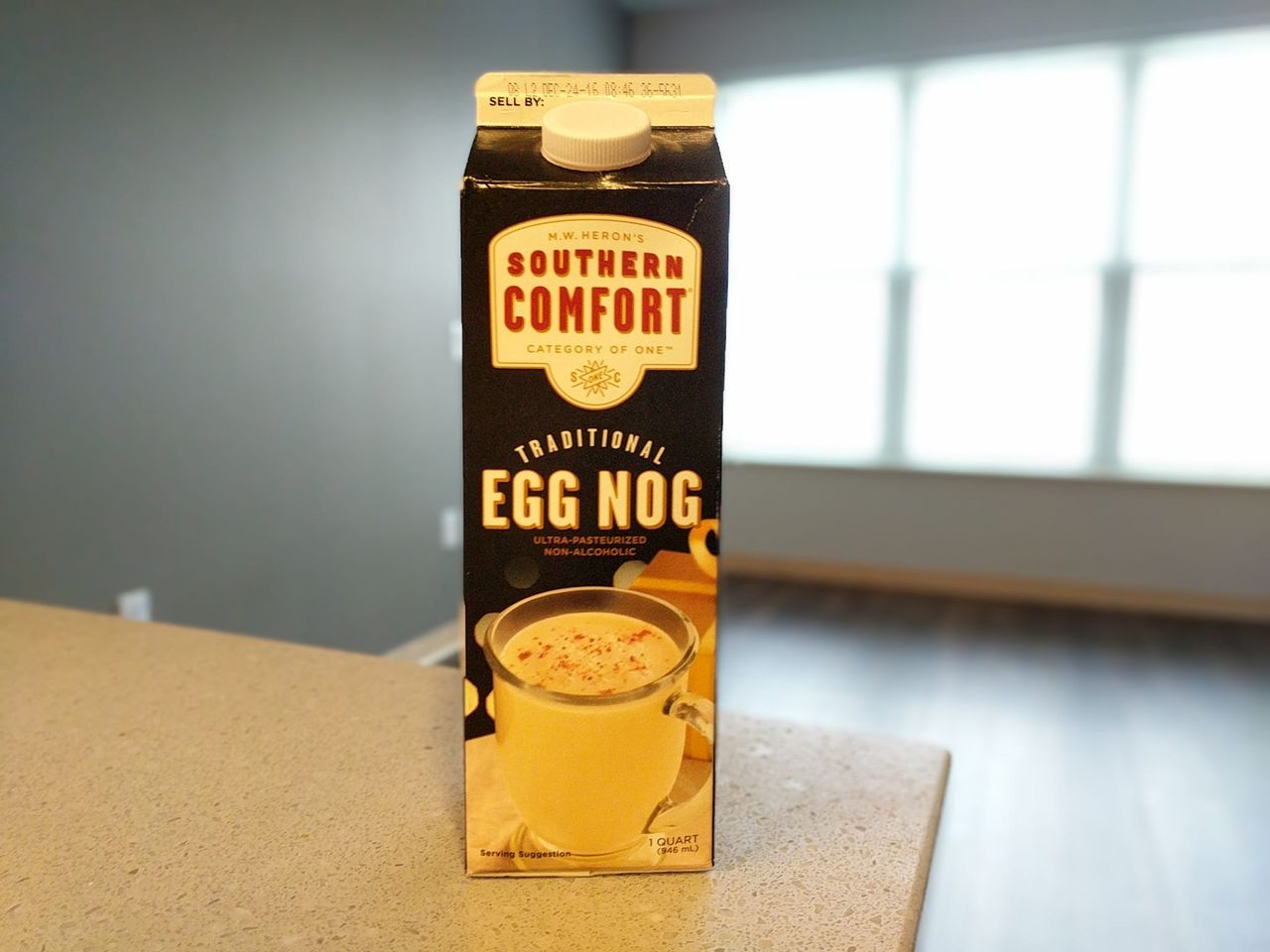A carton of Southern Comfort Traditional Egg Nog on a kitchen counter
