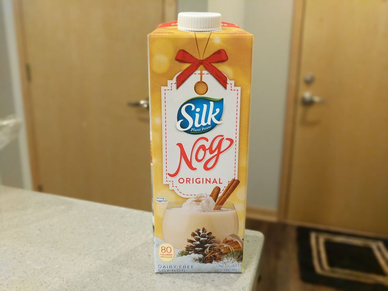 A carton of Silk Nog Original on a kitchen counter